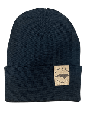 Eco friendly 100% merino wool watchcap beanie with elk cork leather tag in black